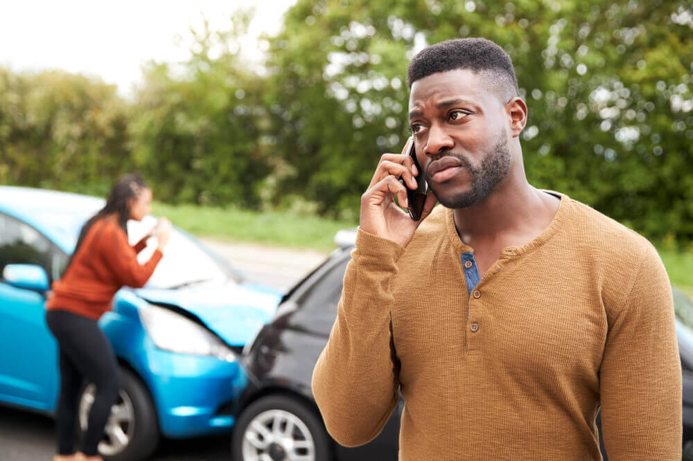 Man involved in car accident calling insurance company to report the incident and file a claim